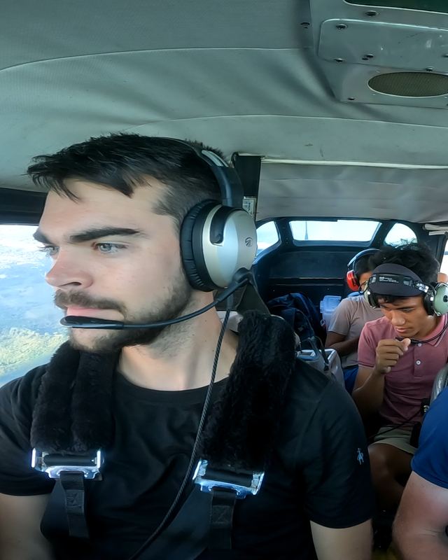 Pilots wearing headsets in a light aircraft cockpit